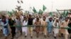 Supporters of the Tehrik-e-Labaik Pakistan (TLP) Islamist political party chant slogans as they march to block the road after the Supreme Court overturned the conviction of a Christian woman sentenced to death for blasphemy against Islam, during a protest